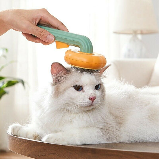 Using the provided product data, here is the rewritten sentence: A person uses the Pumpkin Design Needle Comb for Dog and Cat Grooming to brush a fluffy white and gray cat as it lies relaxed on a wooden table in a cozy, sunlit room.