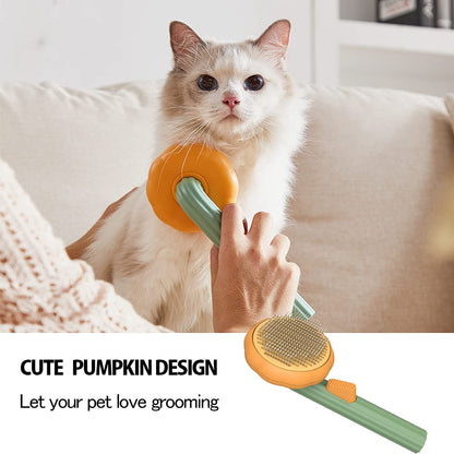 A fluffy white cat is being brushed with the Pumpkin Design Needle Comb for Dog and Cat Grooming, a gentle slicker brush featuring a cute green and orange pumpkin shape. Text below highlights its adorable pumpkin design and invites loving pet owners to enjoy gentle grooming with this charming comb.