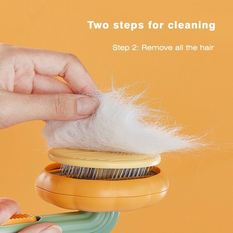 A hand removes a clump of white fur from the Pumpkin Design Needle Comb for Dog and Cat Grooming. Text above reads, Two steps for cleaning. Step 2: Remove all the hair. The background is orange.