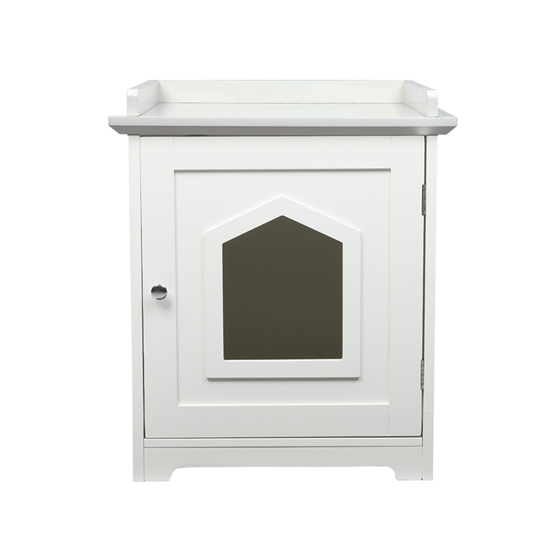 PaWz Cat Litter Box Mat Fully Enclosed is a white cabinet with a single door featuring a decorative window-shaped panel in the center, a round silver knob on the left, and a small raised edge on top. Designed to seamlessly blend style and function, this versatile piece serves as both an elegant cat litter box enclosure and a side table. The cabinet is displayed against a plain white background.