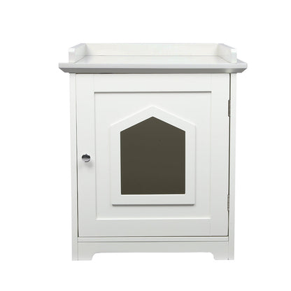 PaWz Cat Litter Box Mat Fully Enclosed is a white cabinet with a single door featuring a decorative window-shaped panel in the center, a round silver knob on the left, and a small raised edge on top. Designed to seamlessly blend style and function, this versatile piece serves as both an elegant cat litter box enclosure and a side table. The cabinet is displayed against a plain white background.
